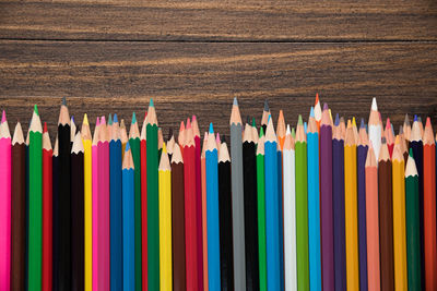 Close-up of multi colored pencils on table