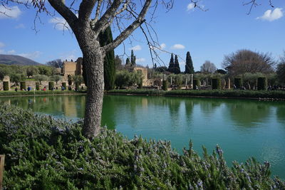 Scenic view of lake by buildings against sky