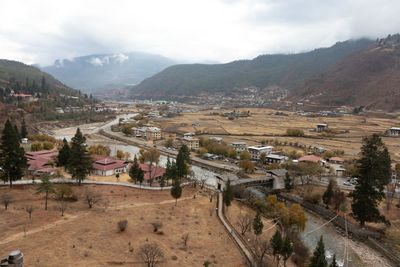 High angle view of road by buildings against sky