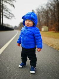 Portrait of cute boy standing outdoors