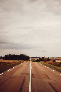 Road passing through landscape against sky