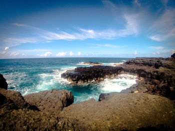 View of calm beach against blue sky