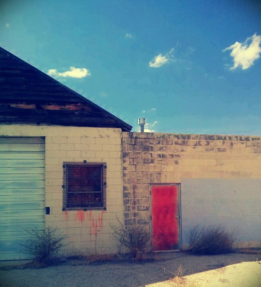 architecture, built structure, building exterior, sky, house, brick wall, wall - building feature, blue, sunlight, residential structure, wall, low angle view, window, cloud, day, outdoors, no people, cloud - sky, door, stone wall