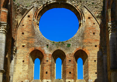 Low angle view of blue sky seen through hole