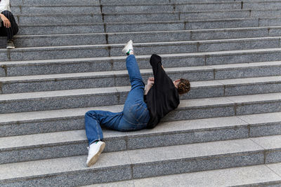 Full length of woman lying on staircase