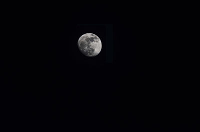 Low angle view of moon against clear sky at night