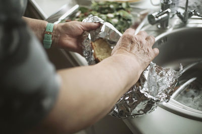 Cropped image of person washing hands