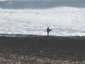 Man standing on beach against sky