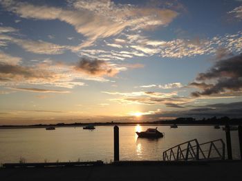 Pier on sea at sunset