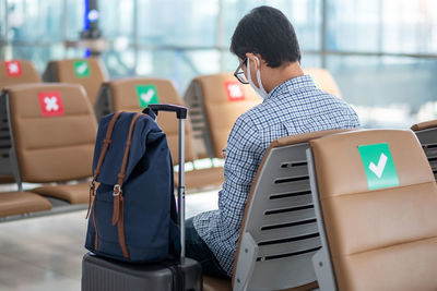 Rear view of man using mobile phone