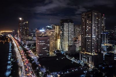 Illuminated cityscape against sky at night