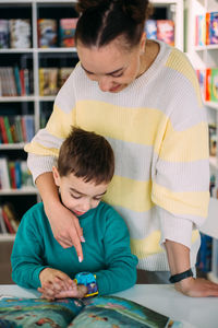 Mom gives her son his first watch. learning to determine the time by the clock.