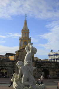 Low angle view of statue against cloudy sky
