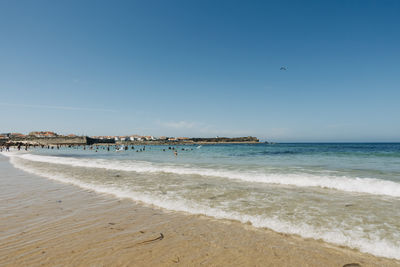 Scenic view of beach against clear blue sky