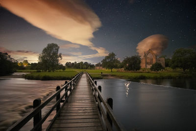 Scenic view of lake against sky at night