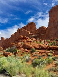 Rock formation in mountain against cloudy sky