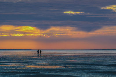 Scenic view of sea against orange sky