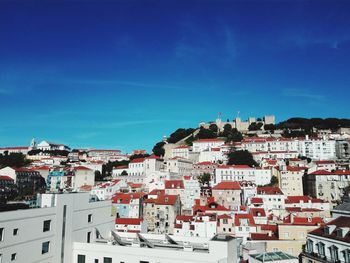 High angle view of cityscape against blue sky