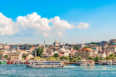 Panoramic view of townscape by canal and buildings against sky