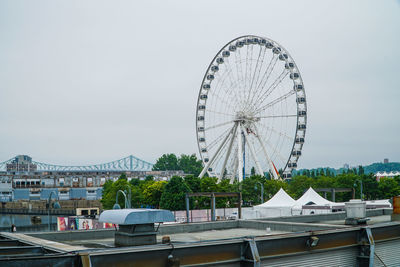 Ferris wheel in city against sky