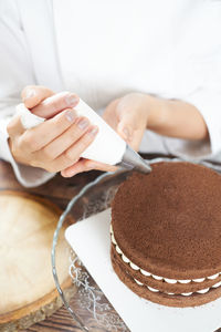 Close-up of hand holding cake