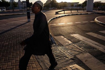 Woman walking on road