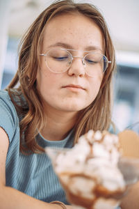 Portrait of young woman holding ice cream cone