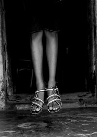 Low section of woman standing on tiled floor