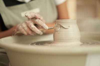 Midsection of person preparing food in kitchen