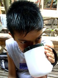 Portrait of boy drinking coffee