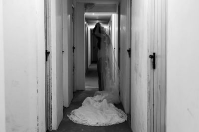 Side view of bride dressing up in corridor