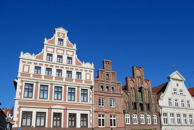 Low angle view of historic building against clear blue sky