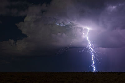 Lightning strikes from a moonlit thunderstorm in grand canyon national park, arizona.