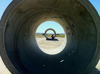 Low angle view of woman standing in tunnel