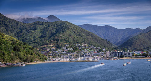 Scenic view of sea by mountains against sky