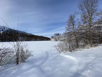 Snow covered field against sky