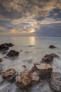 Scenic view of sea against sky at sunset