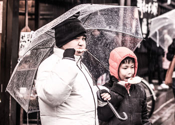 Portrait of couple in snow during rainy season