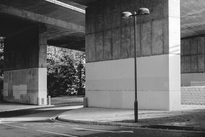 Empty road by buildings in city