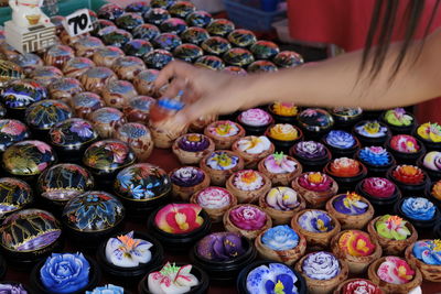 High angle view of human hand holding multi colored candies