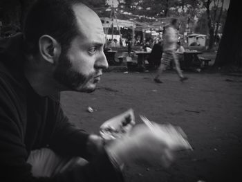 Profile view of man eating snack on street