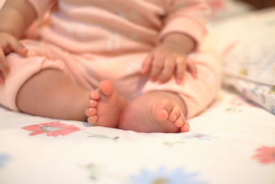 Close-up of baby lying on bed