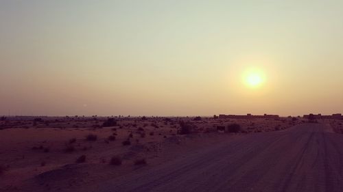 Scenic view of landscape against clear sky during sunset