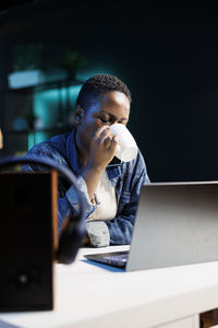 Young woman using laptop at table