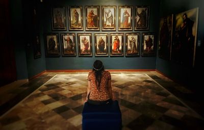 Rear view of woman standing in museum