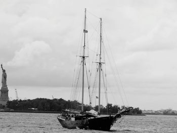 Sailboats sailing on sea against sky