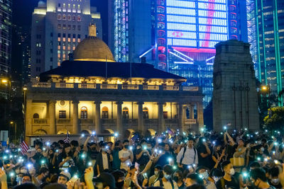 Group of people in illuminated building at night