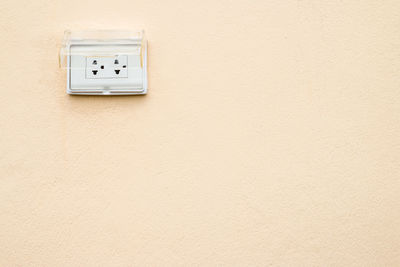Close-up of telephone booth on wall
