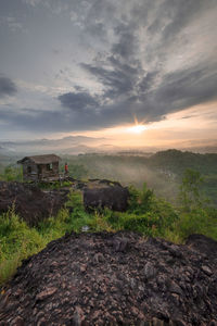Scenic view of land against sky during sunset