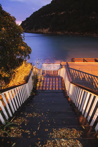 Footbridge over lake against sky